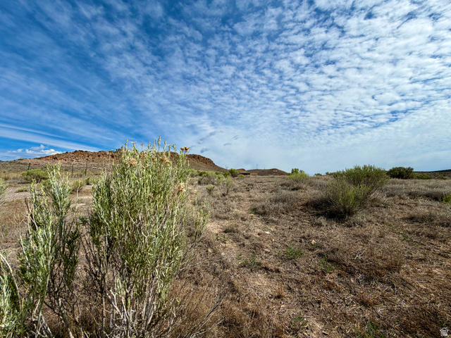 600 East E Street Moroni, UT 84646 - Photo 38 of 38 Expansive undeveloped land featuring natural desert vegetation, distant elevated terrain, and a broad sky with varied cloud formations