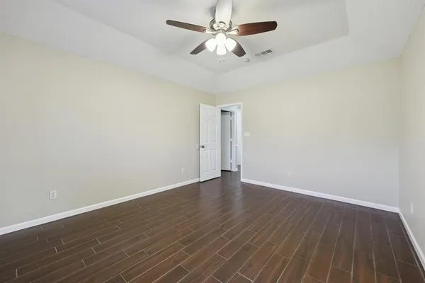 a bathroom with a granite countertop sink a toilet and a mirror
