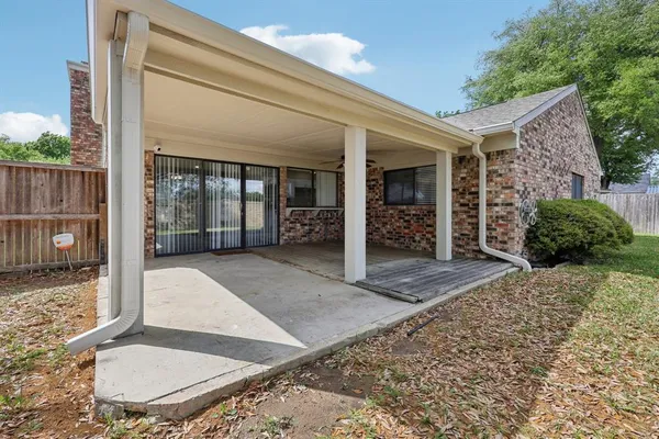 a front view of a house with a garden and trees