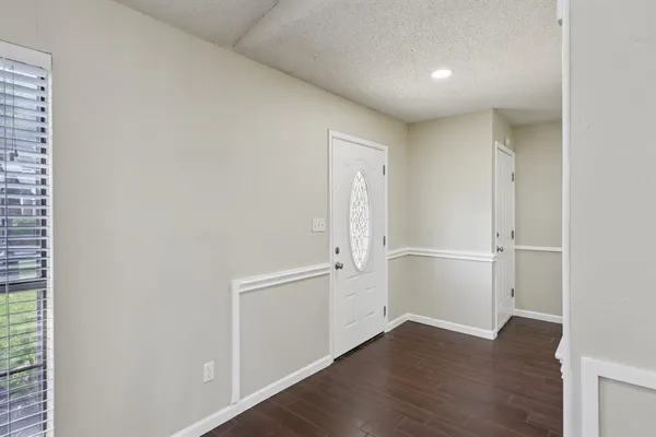 an empty room with wooden floor