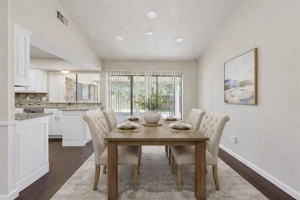 a dining room with furniture and window