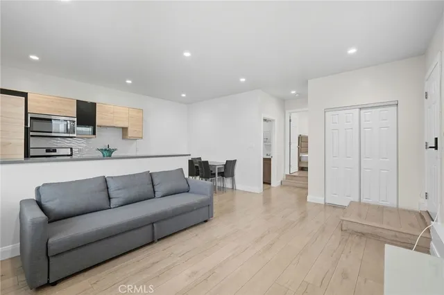 a kitchen with a sink cabinets and a couch