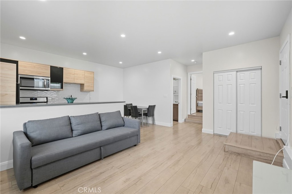 11642 Gothic Avenue Granada Hills, CA 91344 - Photo 11 of 27 a living room with furniture and a flat screen tv