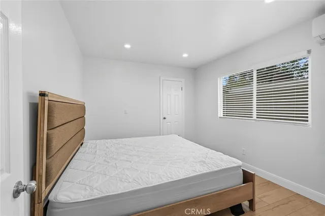 a large bed sitting in a room next to a window