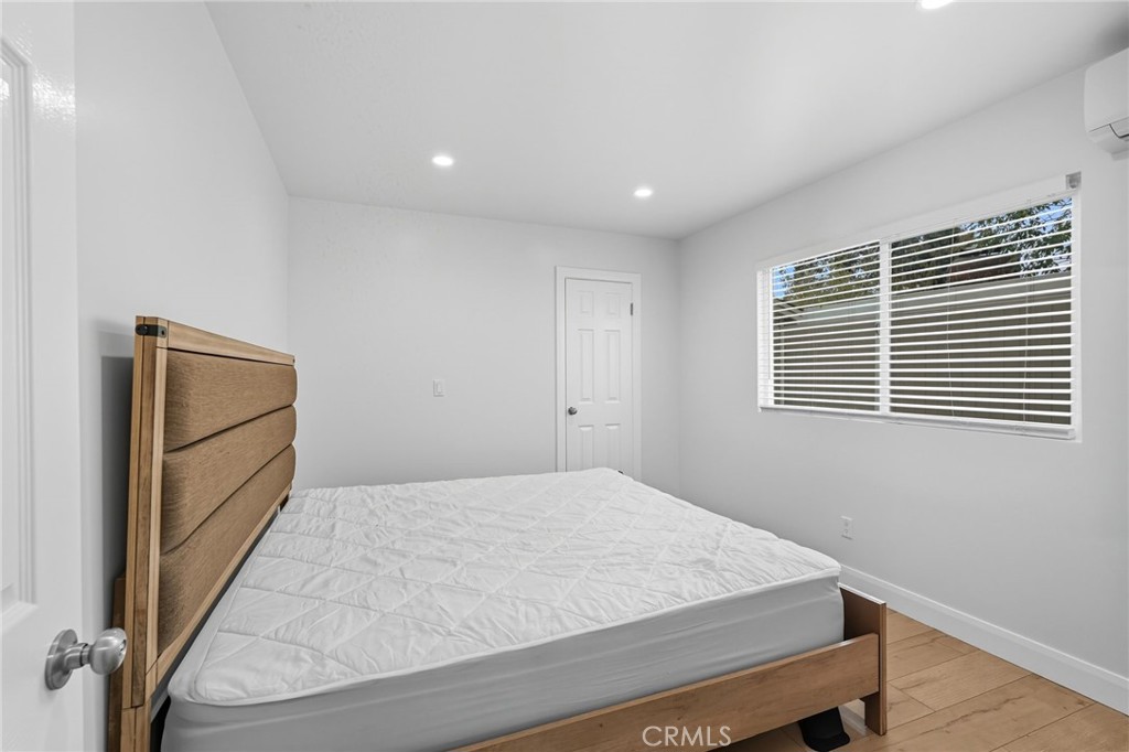 11642 Gothic Avenue Granada Hills, CA 91344 - Photo 17 of 27 a bedroom with a bed and a window
