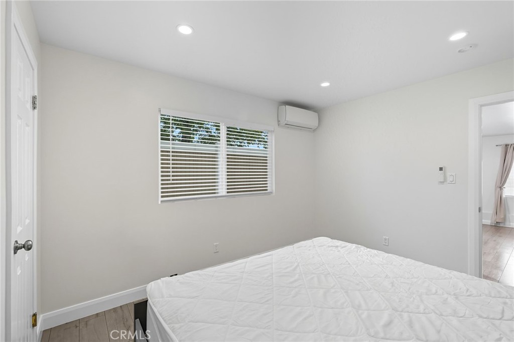 11642 Gothic Avenue Granada Hills, CA 91344 - Photo 20 of 27 a bedroom with a bed and a window