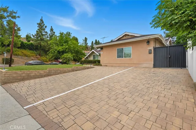 a view of backyard of house and trees
