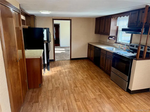 a kitchen with stainless steel appliances a refrigerator and a stove