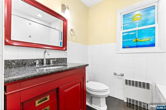 a bathroom with a toilet sink and mirror