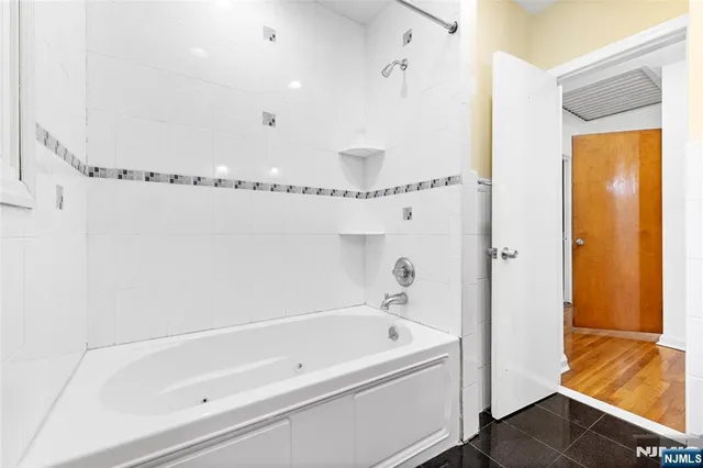 a bathroom with a bathtub and a shower