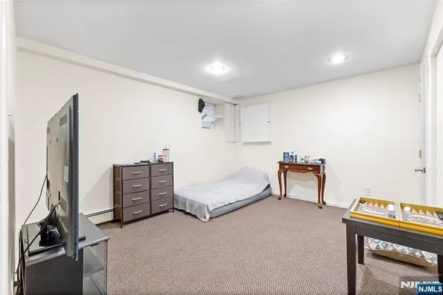 a bedroom with furniture and a gym equipment