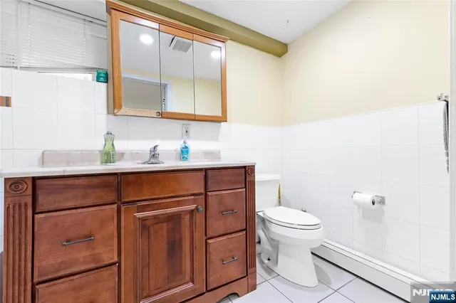 a bathroom with a sink a toilet and mirror