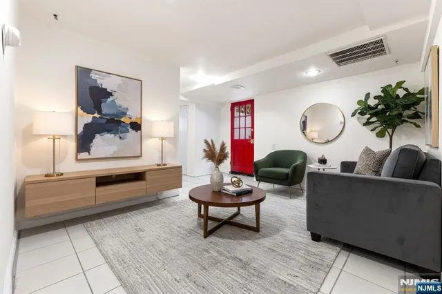 a living room with furniture and a mirror