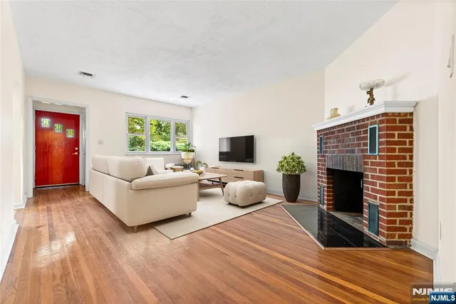 a living room with furniture a fireplace and a flat screen tv
