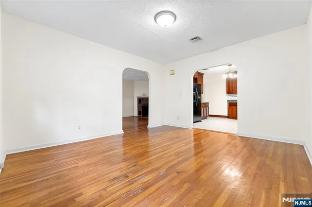 a view of a room with wooden floor and window