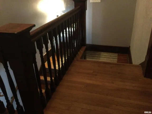 a bedroom with a bed and flat tv screen on the dresser