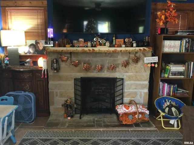 a kitchen with a fireplace and a wooden floor