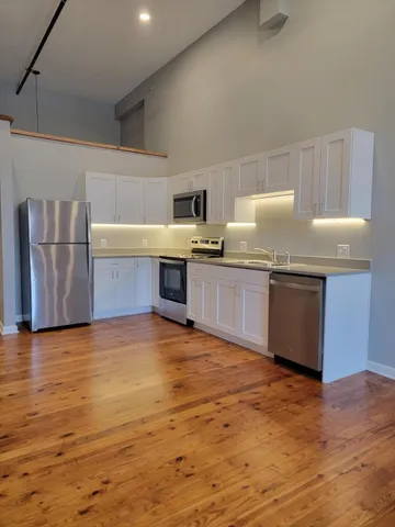 a kitchen with stainless steel appliances granite countertop a sink and stove top oven