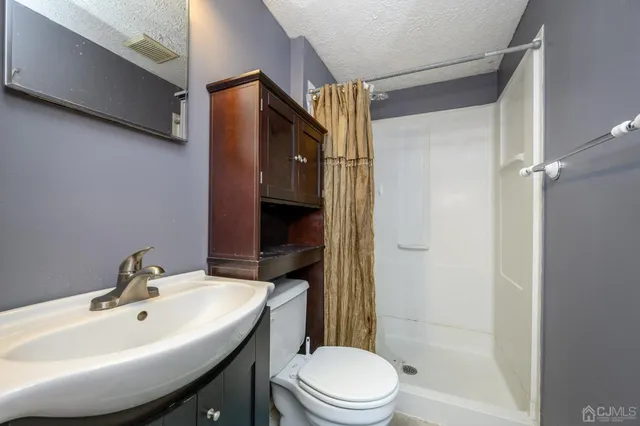 a white toilet sitting next to a bath tub