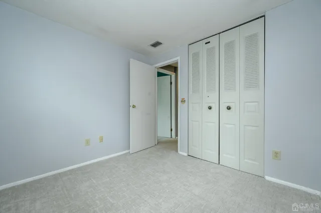 a view of a small yard with large trees and plants