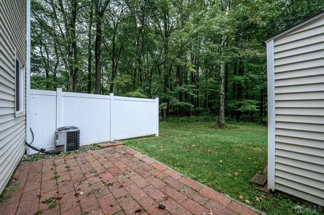 a view of backyard of house and garage