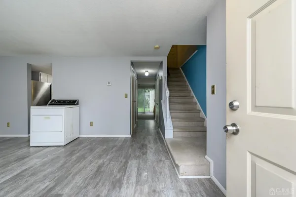 a view of a hallway with wooden floor and entryway