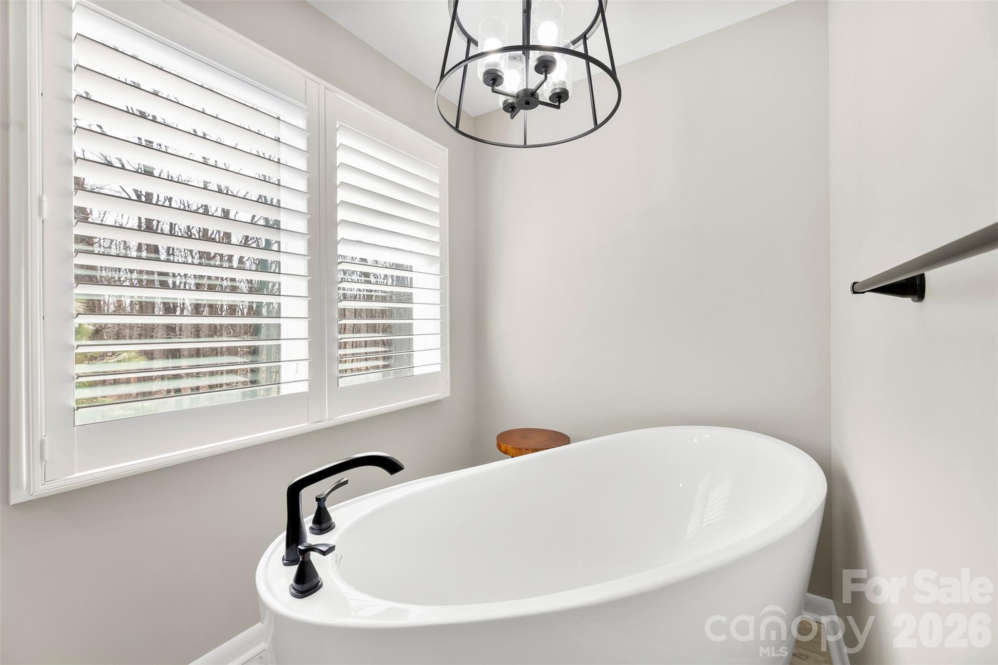 4242 John Ritchie Road Iron Station, NC 28080 - Photo 11 of 46 a bathroom with a white bath tub and a window