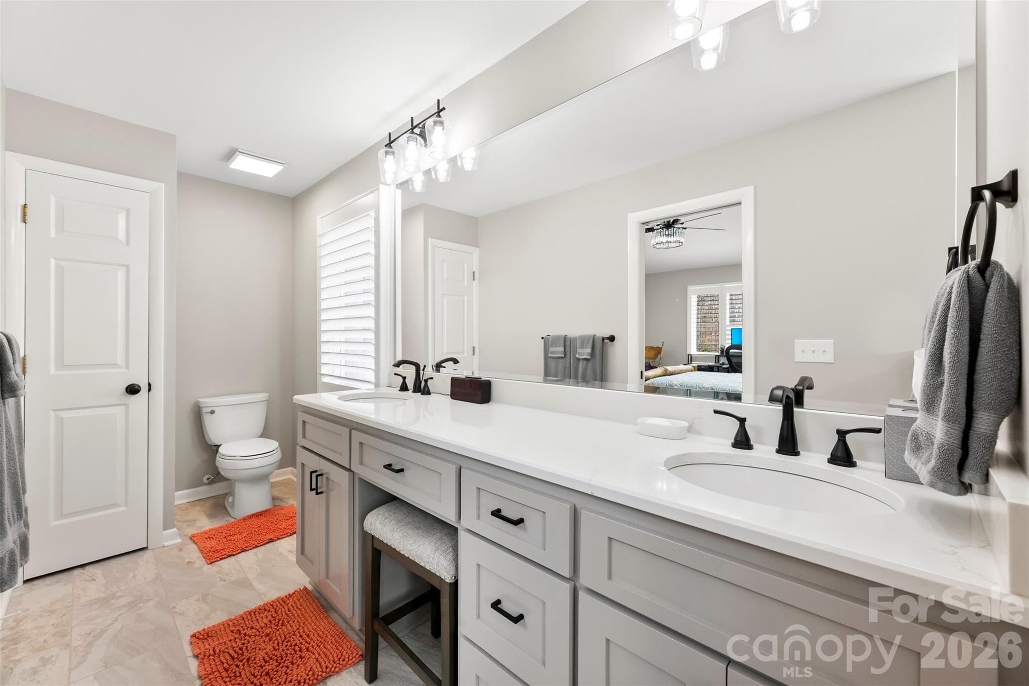 4242 John Ritchie Road Iron Station, NC 28080 - Photo 13 of 46 a bathroom with a double vanity sink mirror and toilet