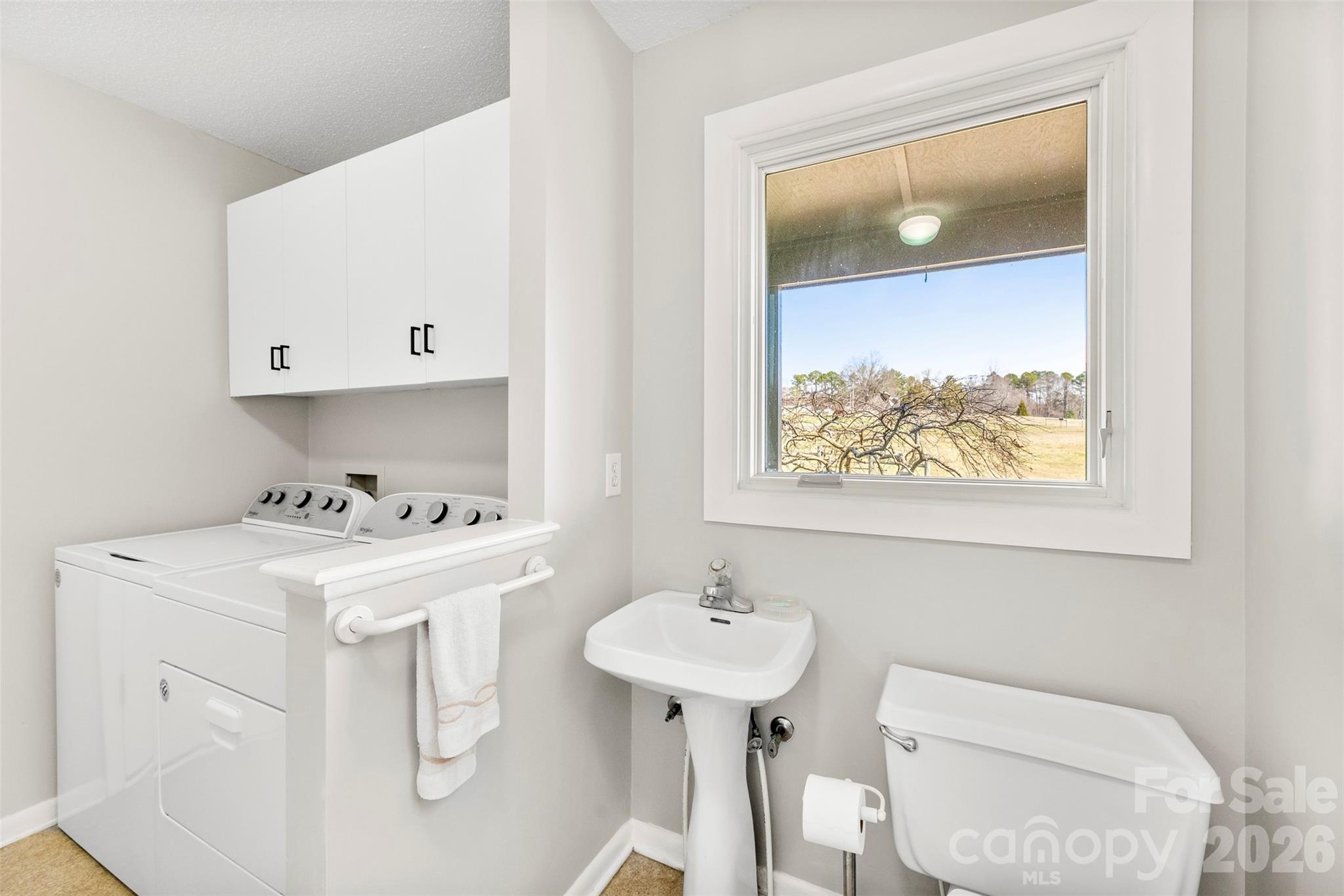4242 John Ritchie Road Iron Station, NC 28080 - Photo 21 of 46 a bathroom with a toilet sink and mirror
