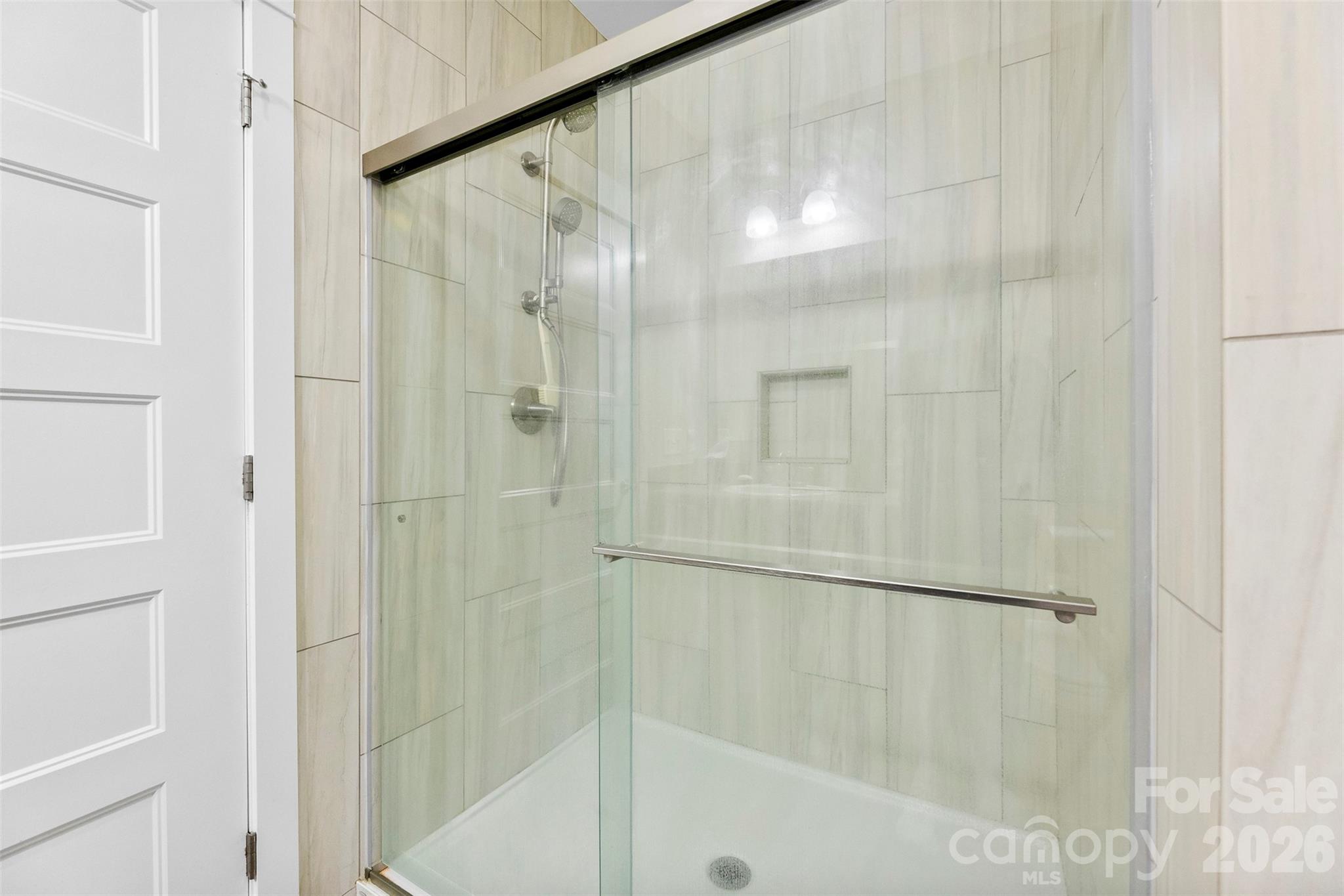 4242 John Ritchie Road Iron Station, NC 28080 - Photo 37 of 46 a bathroom with a glass shower door