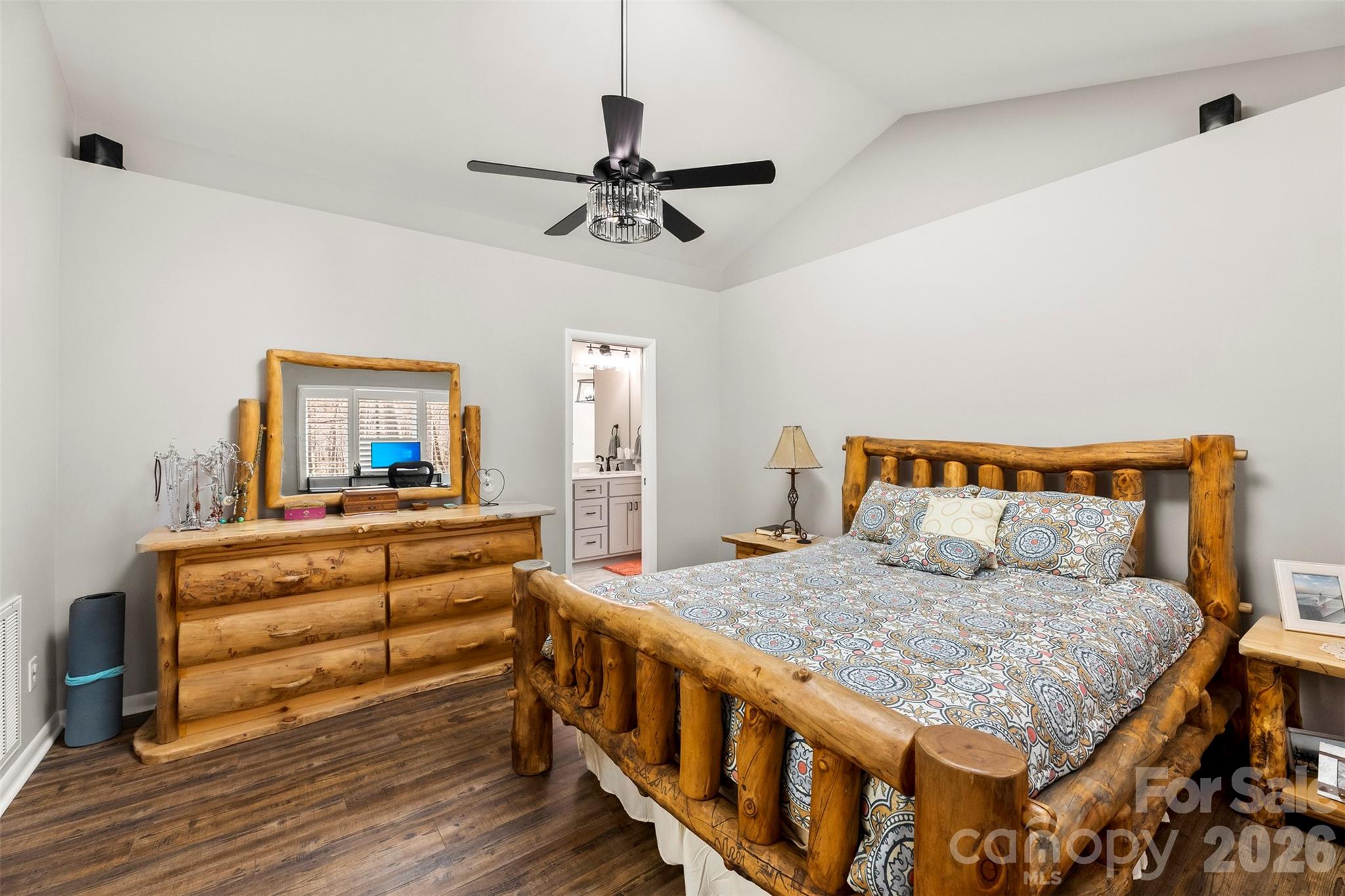 4242 John Ritchie Road Iron Station, NC 28080 - Photo 9 of 46 a bedroom with a bed and a chandelier