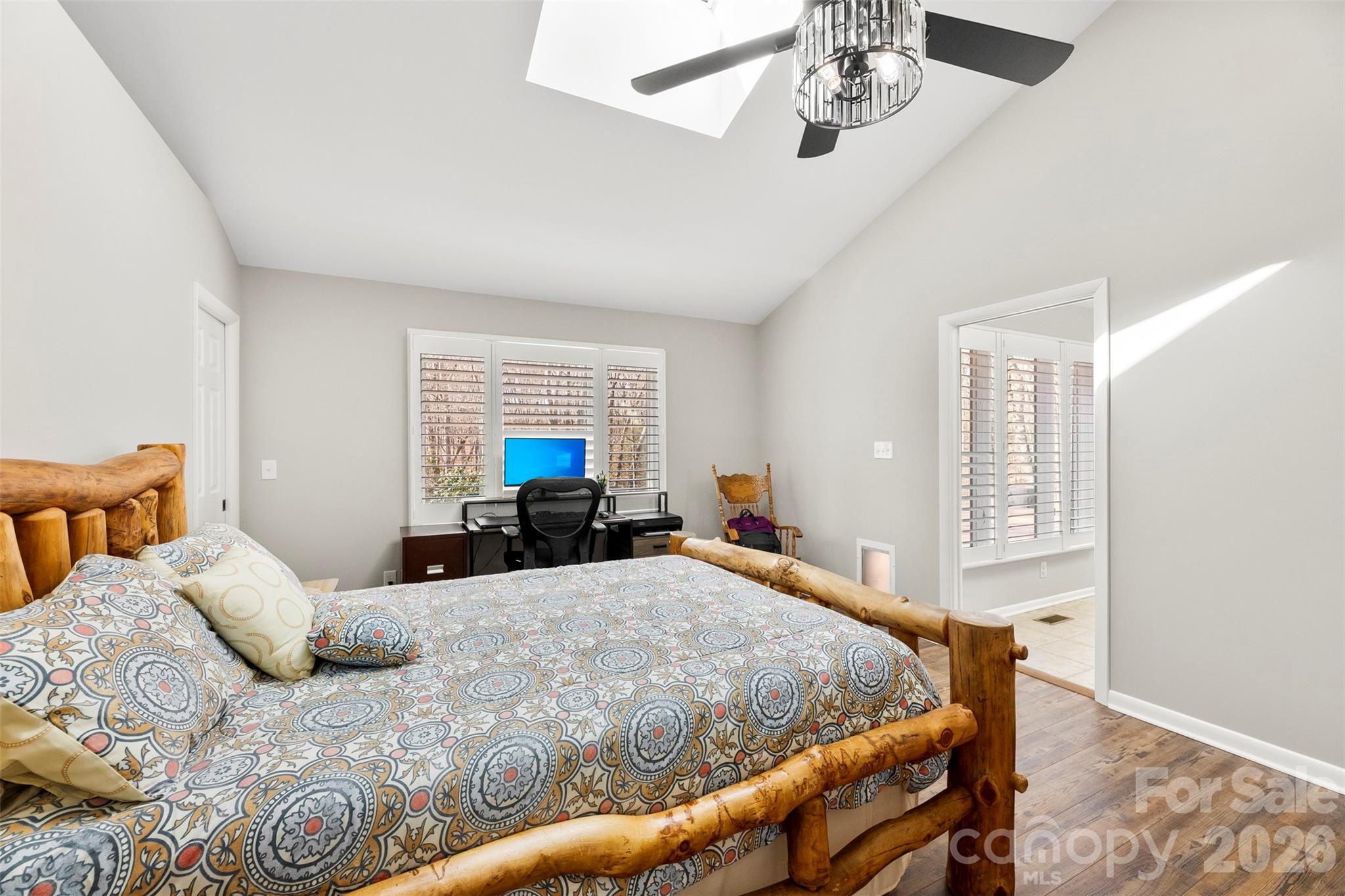 4242 John Ritchie Road Iron Station, NC 28080 - Photo 10 of 46 a bedroom with a bed and a chandelier