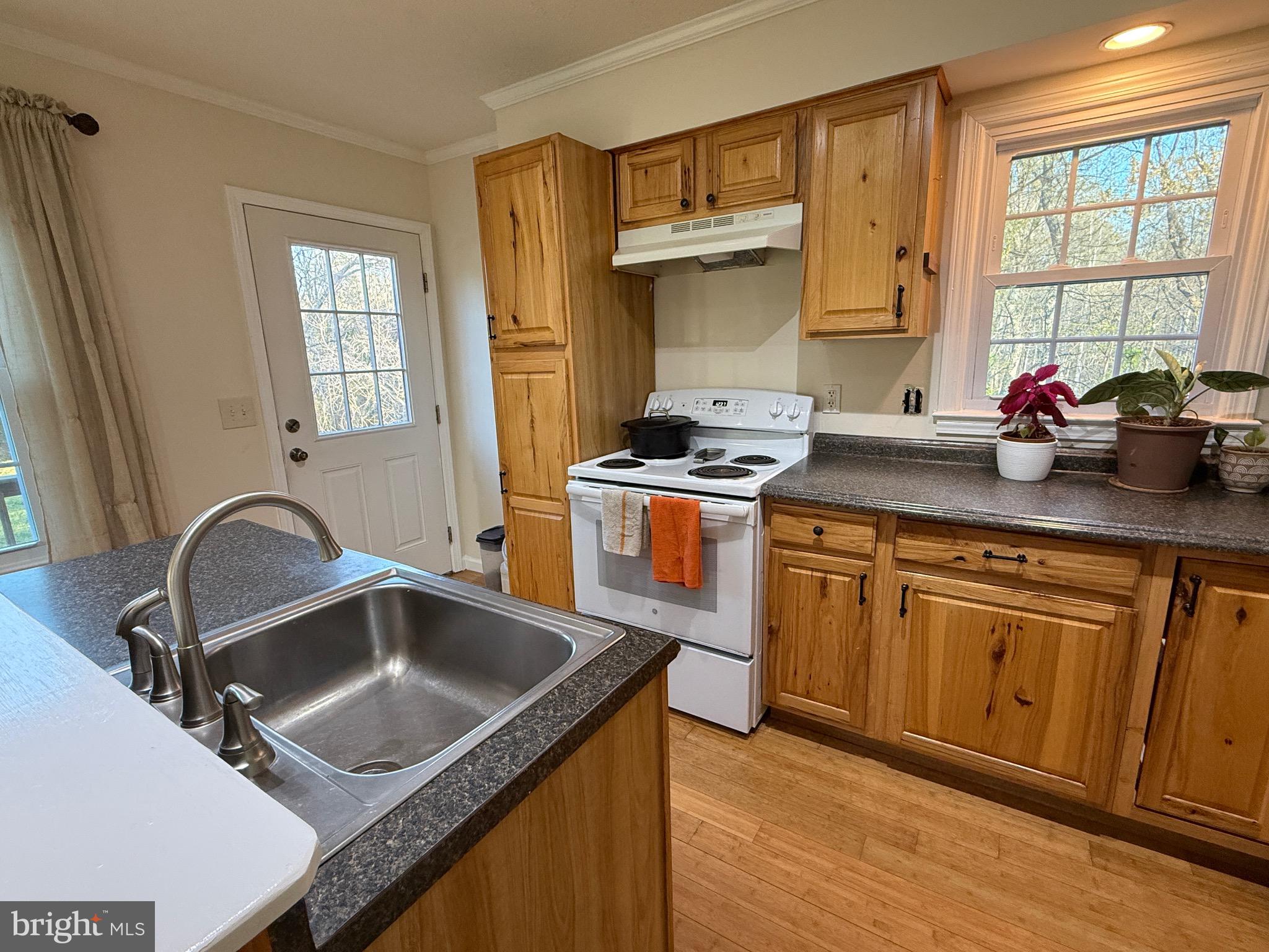 11700 Hazel River Road Rixeyville, VA 22737 - Photo 8 of 35 a kitchen with stainless steel appliances granite countertop a sink stove and refrigerator