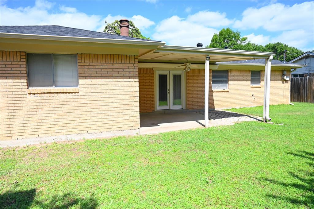 1352 Simpson Drive Hurst, TX 76053 - Photo 1 of 40 Rear exterior featuring a covered patio with a ceiling fan, brick facade, and french doors