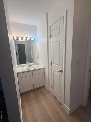 a bathroom with a sink vanity and mirror