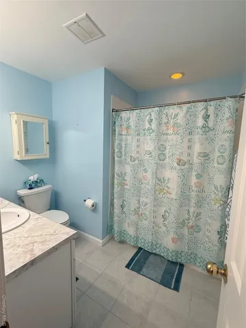 a bathroom with a shower and a sink
