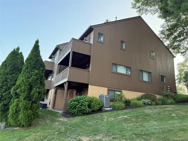 a aerial view of a house next to a big yard and large trees