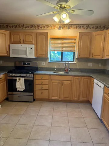 a kitchen with a stove a sink and a refrigerator