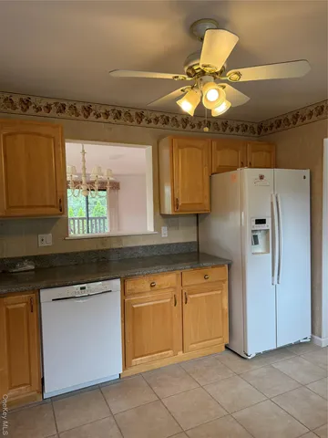 a kitchen with a refrigerator and cabinets