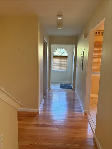 a view of a hallway with wooden floor