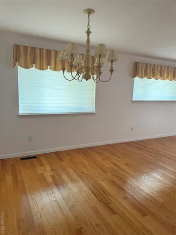 a view of wooden floor and cabinet in a room