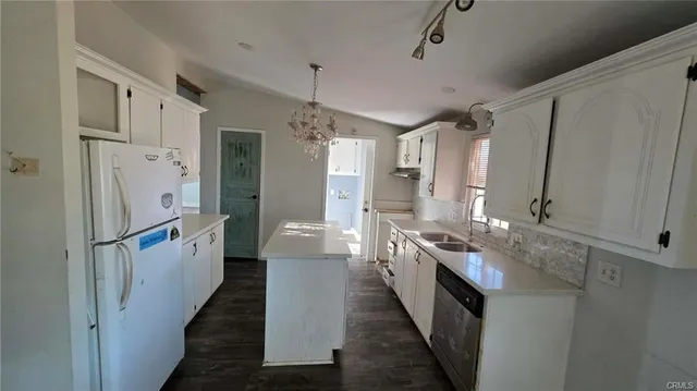 a kitchen with stainless steel appliances a sink stove and refrigerator
