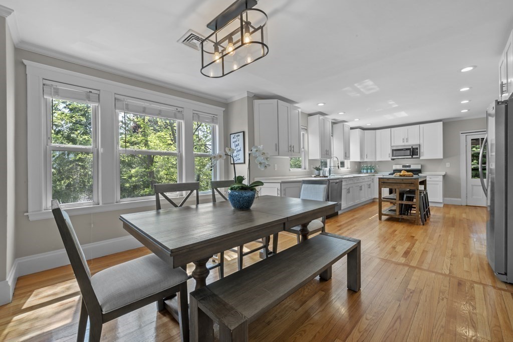 26 Cedar Street, Unit 2 Marblehead, MA 01945 - Photo 11 of 37 a dining room with furniture a chandelier and wooden floor