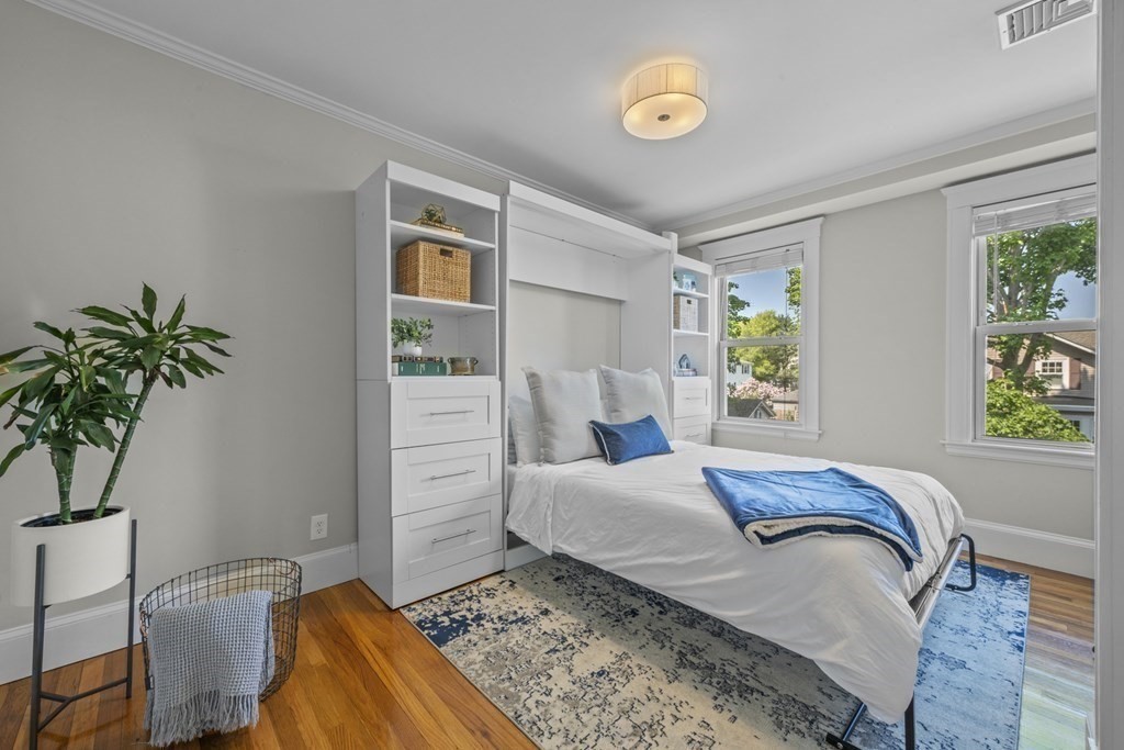 26 Cedar Street, Unit 2 Marblehead, MA 01945 - Photo 22 of 37 a bedroom with a bed and a potted plant