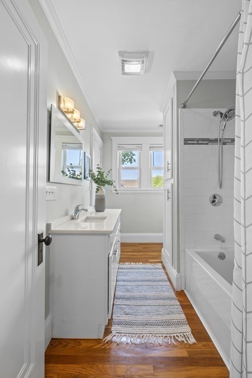 26 Cedar Street, Unit 2 Marblehead, MA 01945 - Photo 23 of 37 a bathroom with a sink a mirror and a bathtub