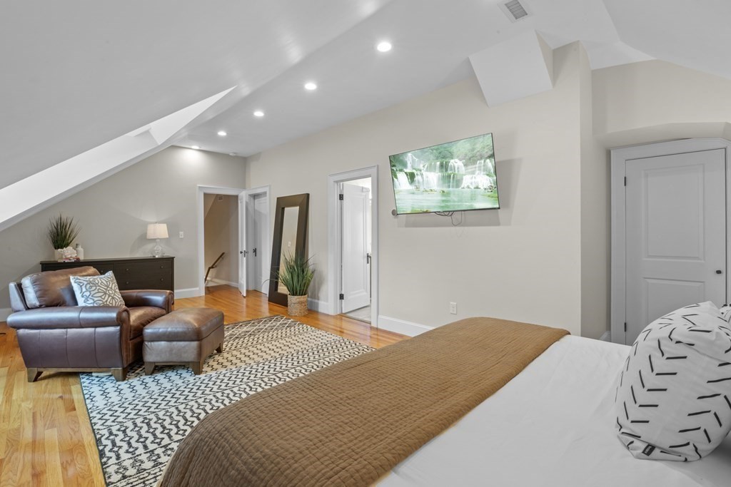 26 Cedar Street, Unit 2 Marblehead, MA 01945 - Photo 28 of 37 a bedroom with a bed and glass window