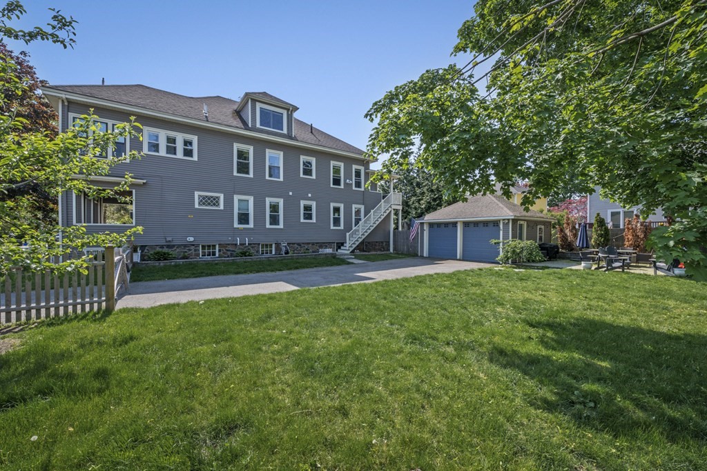 26 Cedar Street, Unit 2 Marblehead, MA 01945 - Photo 3 of 37 a front view of a house with garden