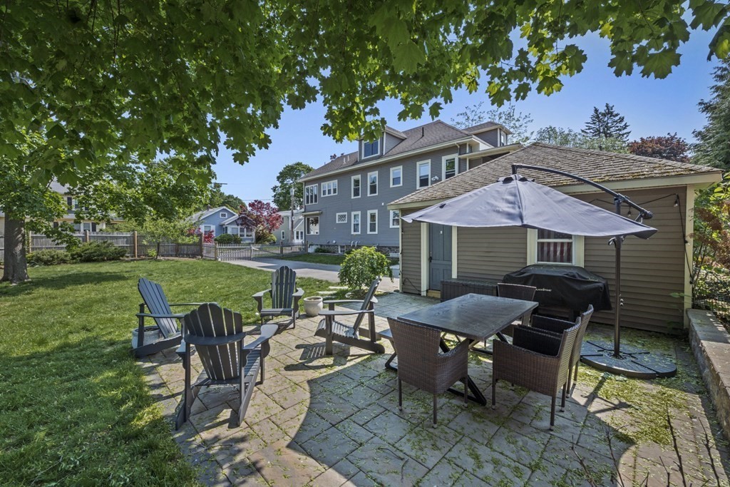 26 Cedar Street, Unit 2 Marblehead, MA 01945 - Photo 37 of 37 a view of a patio with table and chairs under an umbrella