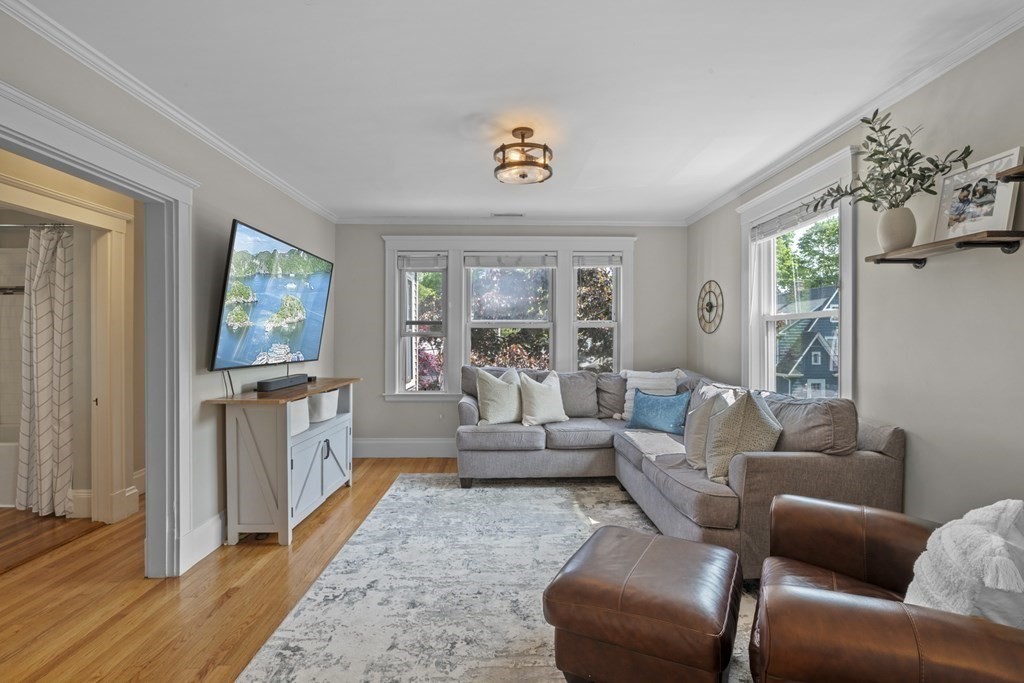 26 Cedar Street, Unit 2 Marblehead, MA 01945 - Photo 9 of 37 a living room with furniture a chandelier and a window