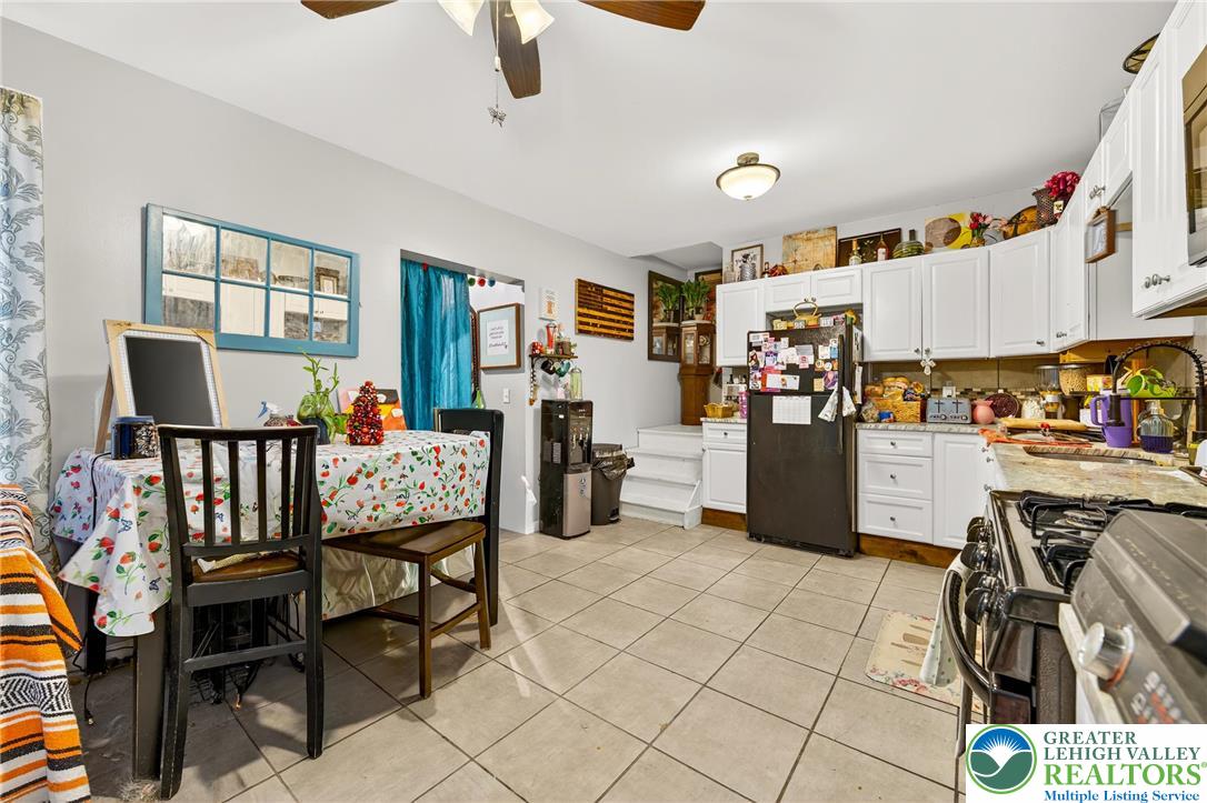 22 South 1st Street Bangor, PA 18013 - Photo 46 of 79 a open kitchen with stainless steel appliances granite countertop a stove top oven a dining table and chairs with wooden floor